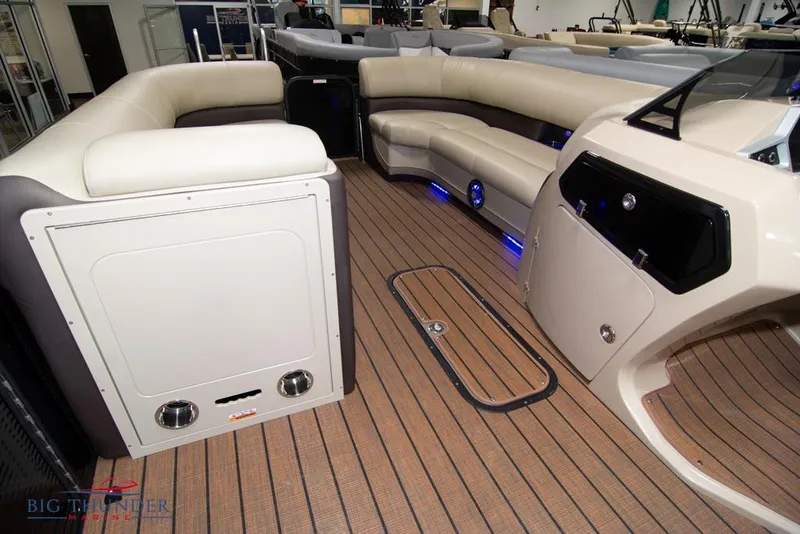 Slide: The Image of 2022 Manitou 25 Oasis SR SHP boat interior with luxurious seating and wood-like flooring. - 32