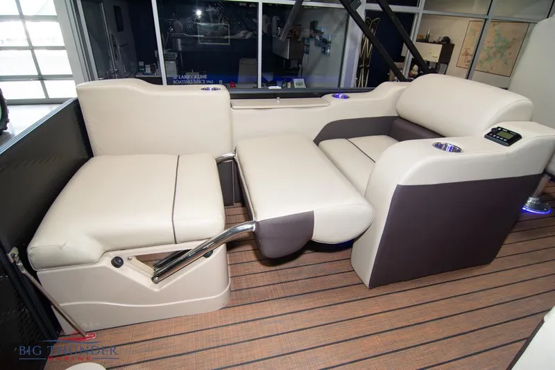 Slide: The Image of 2022 Manitou 25 Oasis SR SHP boat interior with beige and brown seating. - 35