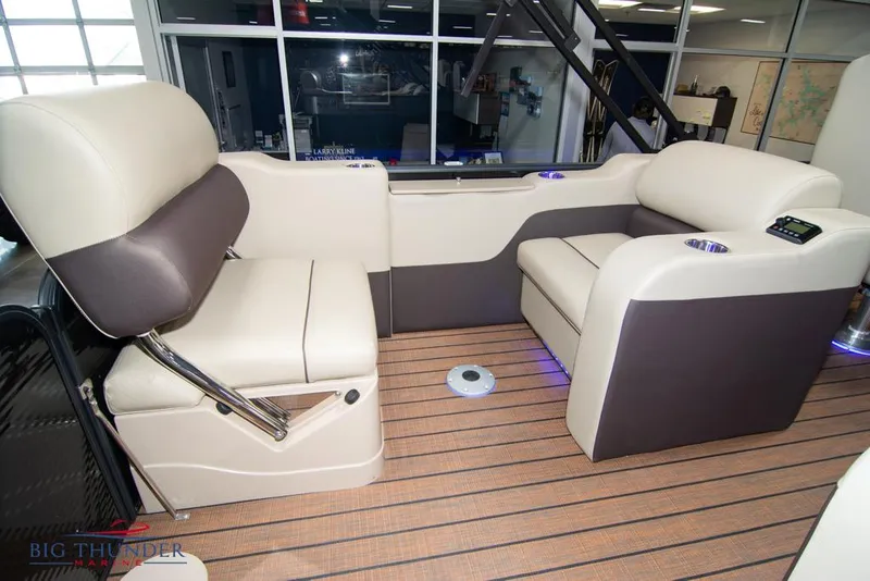 Slide: The Image of 2022 Manitou 25 Oasis SR SHP boat interior with beige and brown seating. - 36