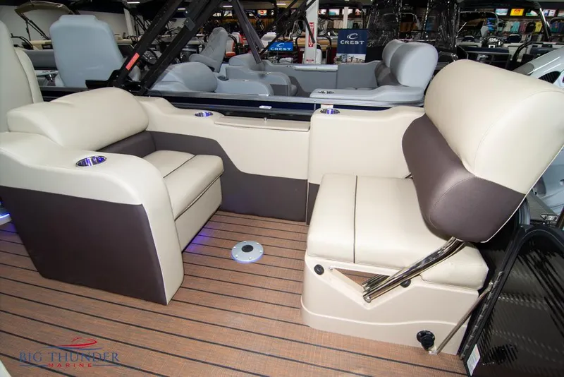 Slide: The Image of 2022 Manitou 25 Oasis SR SHP boat interior with beige and brown seating. - 39