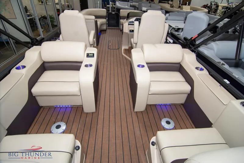 Slide: The Image of 2022 Manitou 25 Oasis SR SHP boat interior with luxurious seating and LED lighting. - 41