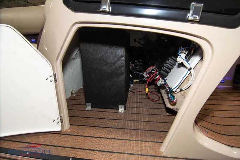 Slide: The Image of 2022 Manitou 25 Oasis SR SHP interior storage compartment with wiring and components. - 45
