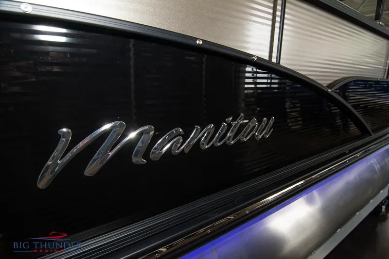 Slide: The Image of 2022 Manitou 25 Oasis SR SHP pontoon boat side view with logo. - 8