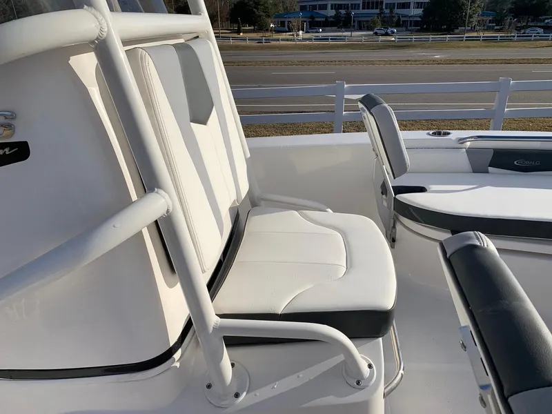 Slide: The Image of 2024 Robalo 206 Cayman boat seating area with white and gray cushions. - 13