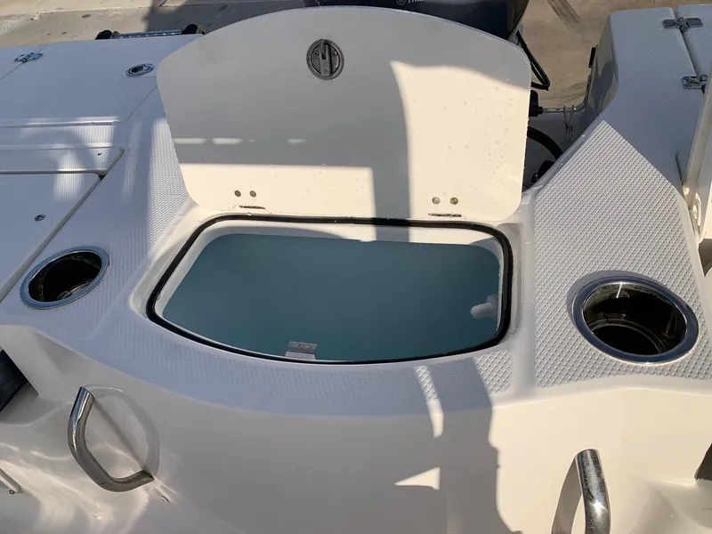 Slide: The Image of 2024 Robalo 206 Cayman boat livewell and cup holders. - 16