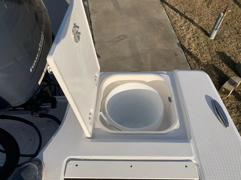 Slide: The Image of 2024 Robalo 206 Cayman boat with open storage compartment. - 7