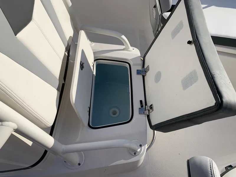 Slide: The Image of 2024 Robalo 206 Cayman boat with open storage compartment. - 10