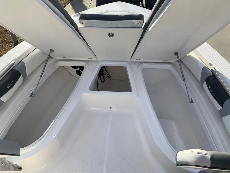Slide: The Image of 2024 Robalo 206 Cayman boat with open storage compartments. - 11