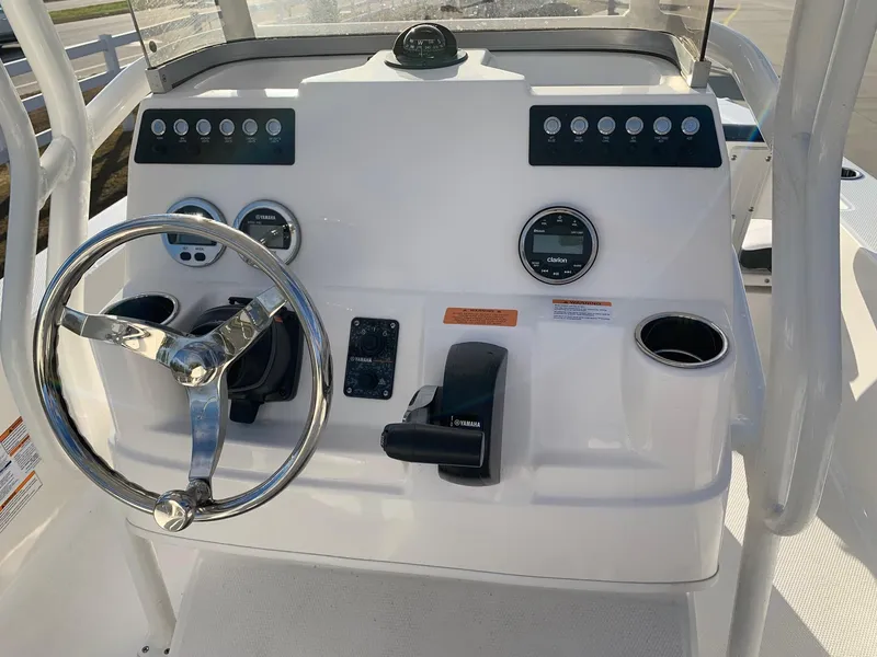 Slide: The Image of 2024 Robalo 206 Cayman boat console with steering wheel and controls. - 14
