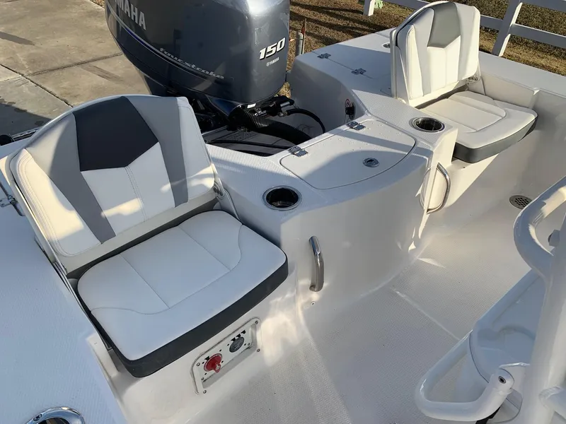 Slide: The Image of 2024 Robalo 206 Cayman boat interior with Yamaha 150 engine and cushioned seating. - 15