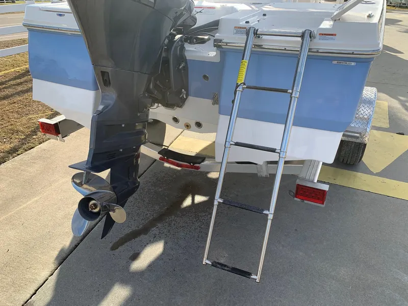 Slide: The Image of 2024 Robalo 206 Cayman boat rear view with outboard motor and ladder. - 17