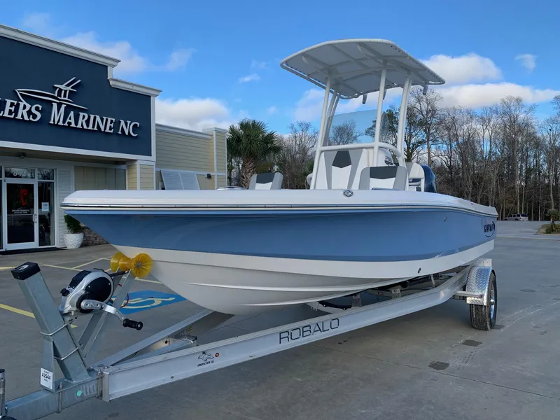Slide: The Image of 2024 Robalo 206 Cayman boat on a trailer outside a dealership. - 3