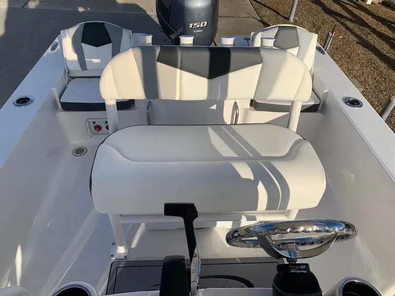 Slide: The Image of 2024 Robalo 206 Cayman boat interior with seating and steering wheel. - 9