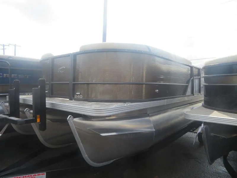 Slide: The Image of 2023 Crest Classic LX 240 SLC CPT pontoon boat in a showroom. - 1