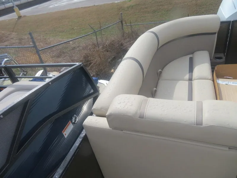 Slide: The Image of 2023 Crest Classic LX 240 SLC CPT boat with beige seating and sleek design. - 10