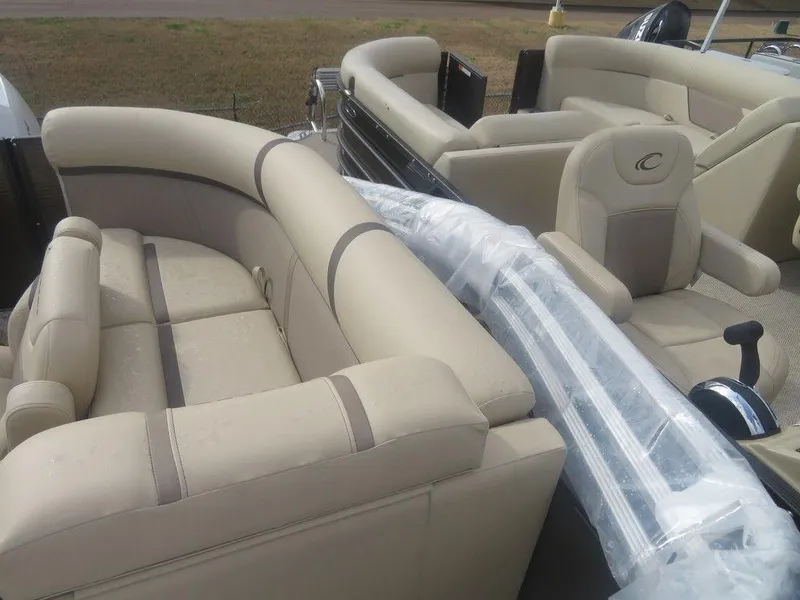 Slide: The Image of 2023 Crest Classic LX 240 SLC CPT boat with beige seating and wrapped accessories. - 11