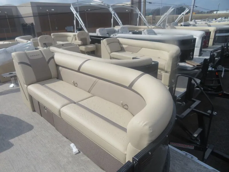 Slide: The Image of 2023 Crest Classic LX 240 SLC CPT pontoon boat with beige seating and modern design. - 4