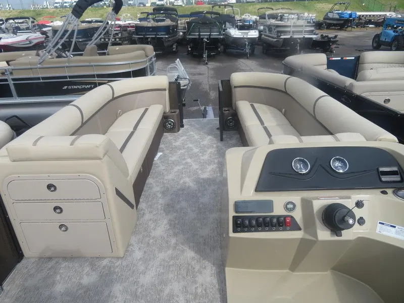 Slide: The Image of 2023 Crest Classic LX 240 SLC CPT pontoon boat interior with beige seating and control panel. - 8