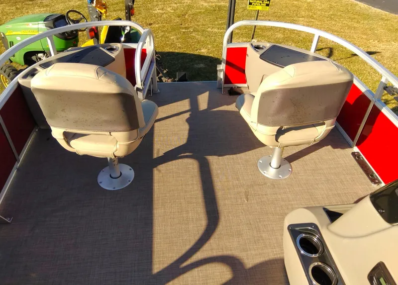 Slide: The Image of 2023 Sun Tracker Bass Buggy 18 DLX pontoon boat interior with two beige seats. - 3