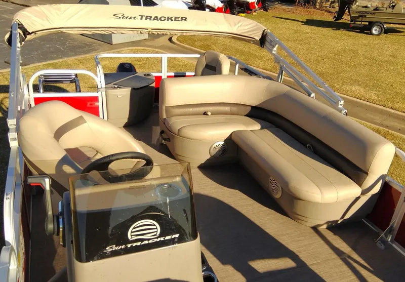 Slide: The Image of 2023 Sun Tracker Bass Buggy 18 DLX pontoon boat interior with beige seating. - 5