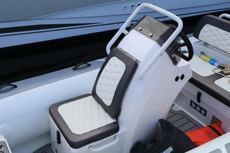 Slide: The Image of 2023 Highfield 390 Sport boat interior with white cushioned seating and steering console. - 15