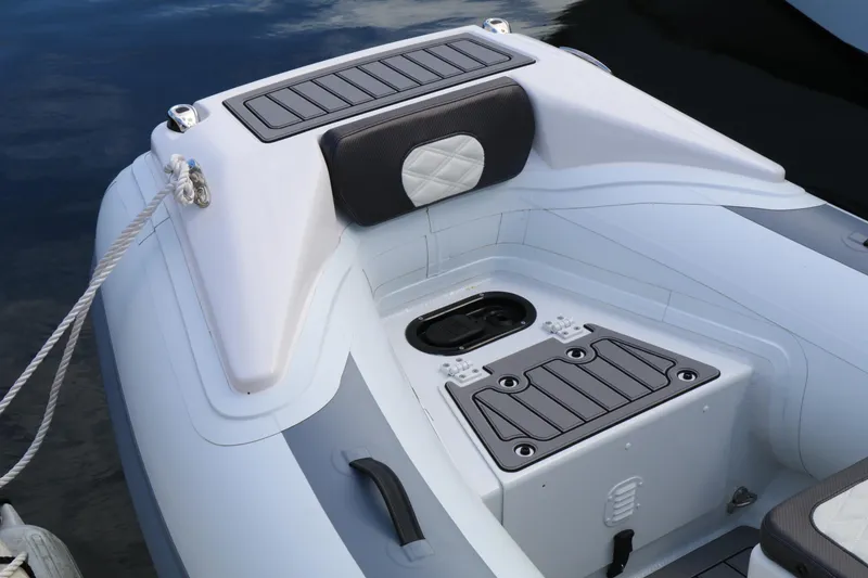 Slide: The Image of 2023 Highfield 390 Sport boat interior with storage compartments and cushioned seating. - 16