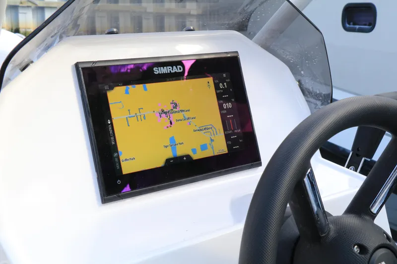 Slide: The Image of 2023 Highfield 390 Sport boat dashboard with Simrad navigation display. - 8