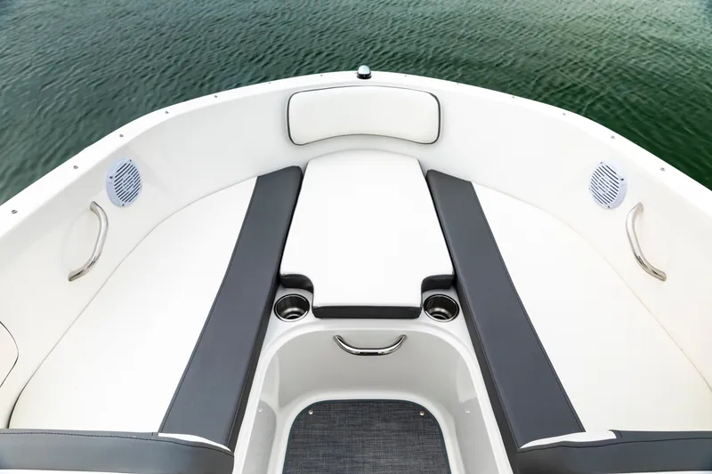 Slide: The Image of 2023 Bayliner VR4 OB boat interior with cushioned seating and cup holders. - 13