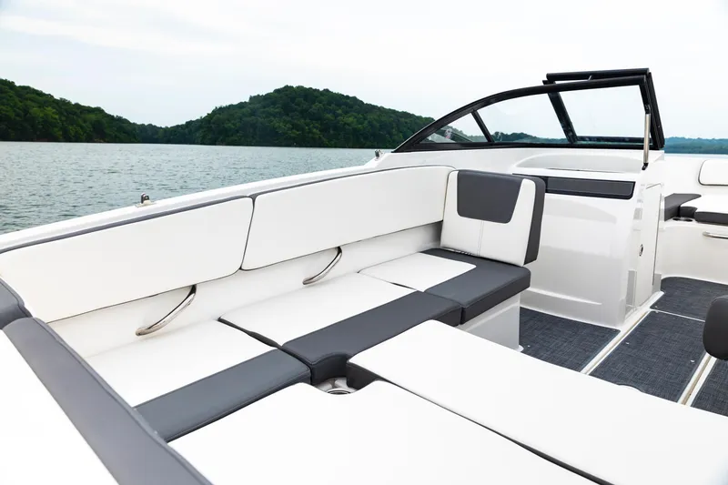 Slide: The Image of 2023 Bayliner VR4 OB boat interior with sleek seating on a serene lake. - 16