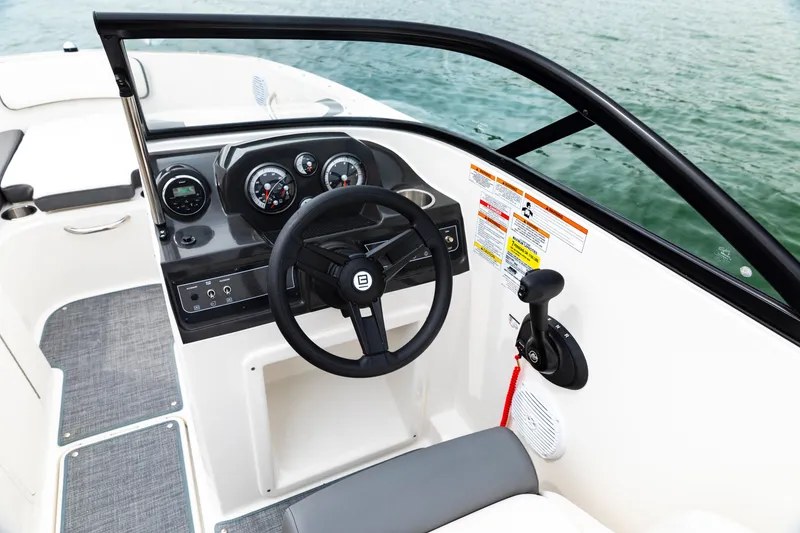 Slide: The Image of 2023 Bayliner VR4 OB boat cockpit with steering wheel and control panel. - 18