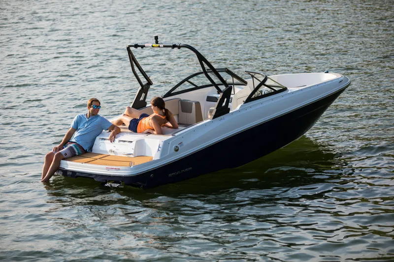 Slide: The Image of 2023 Bayliner VR4 OB boat with two people relaxing on the water. - 29