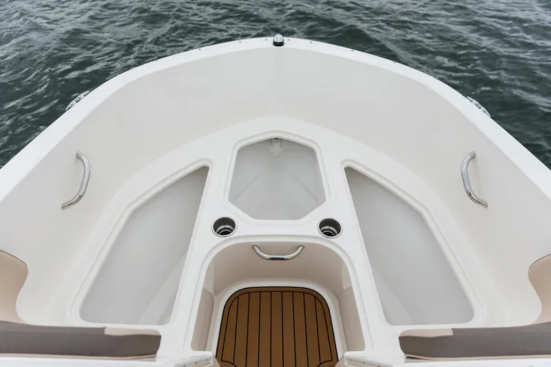 Slide: The Image of 2023 Bayliner VR4 OB boat bow with seating and cup holders on water. - 33