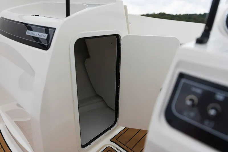 Slide: The Image of 2023 Bayliner VR4 OB boat storage compartment with open door, showcasing interior space. - 38
