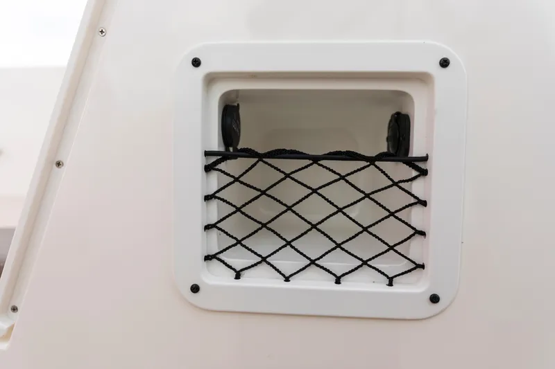 Slide: The Image of 2023 Bayliner VR4 OB boat storage compartment with netting. - 39