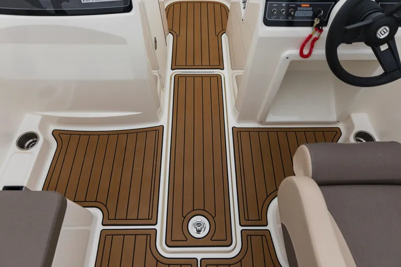 Slide: The Image of 2023 Bayliner VR4 OB boat interior with teak-style flooring and steering console. - 41