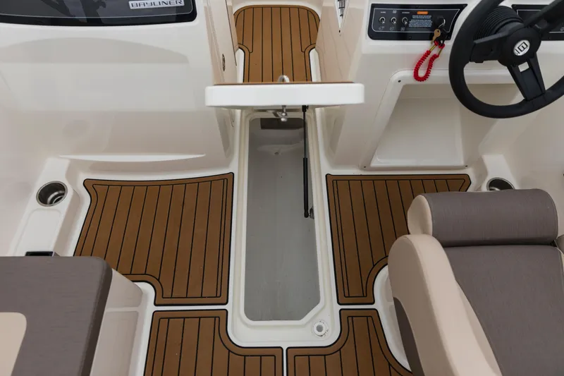 Slide: The Image of 2023 Bayliner VR4 OB boat interior with wood-style flooring and steering wheel. - 42