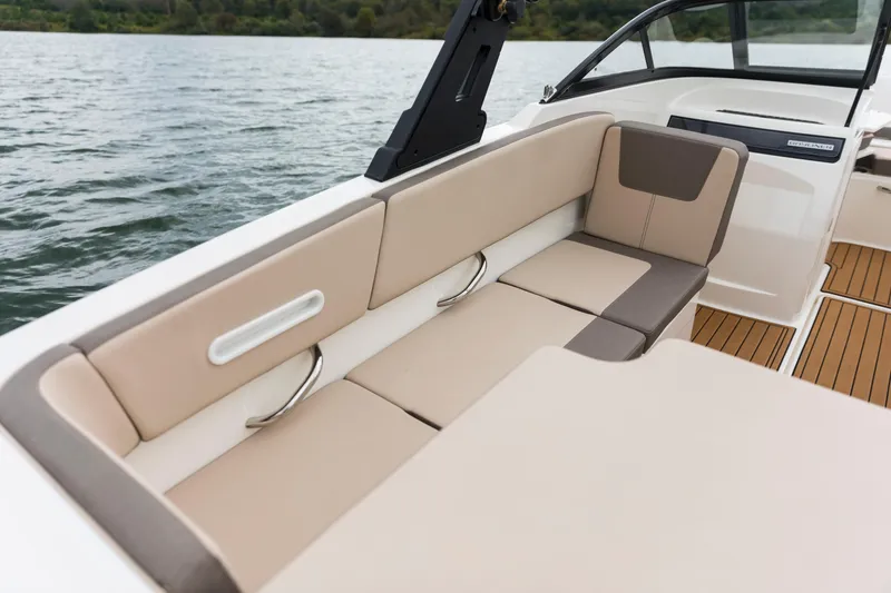 Slide: The Image of 2023 Bayliner VR4 OB boat interior with beige seating and wooden flooring. - 45