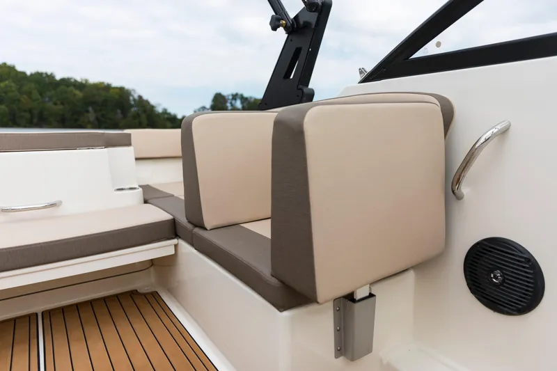Slide: The Image of 2023 Bayliner VR4 OB boat interior with beige seating and wood flooring. - 47