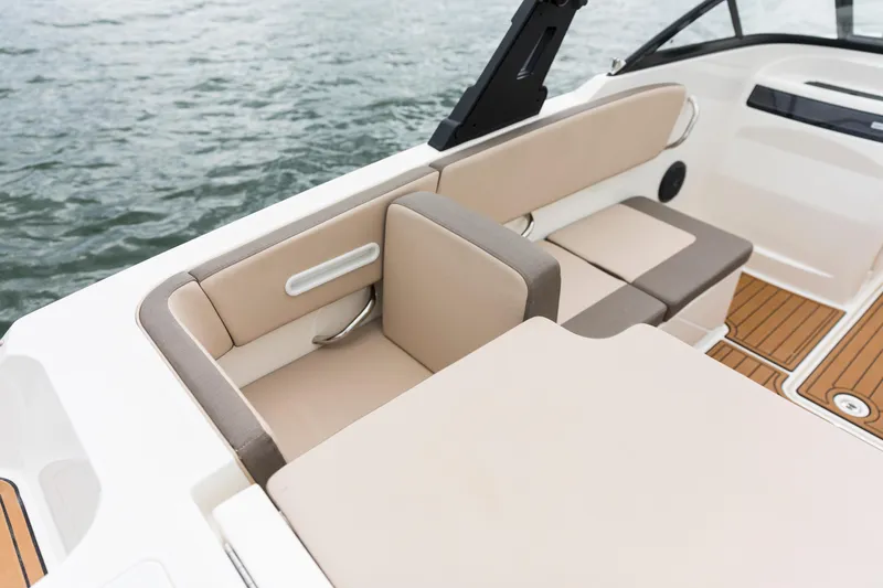 Slide: The Image of 2023 Bayliner VR4 OB boat interior with beige seating and wood accents. - 49
