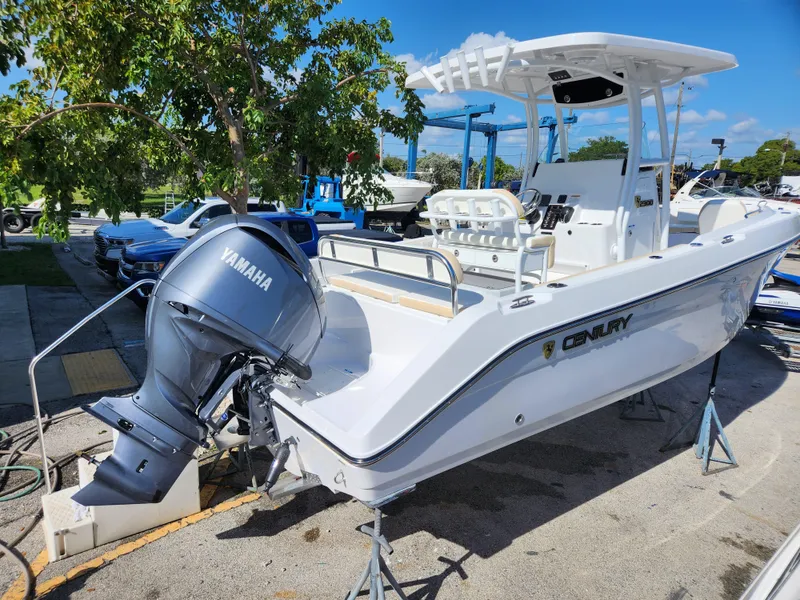 Slide: The Image of 2023 Century 2301 Center Console boat with Yamaha engine, parked outdoors. - 2