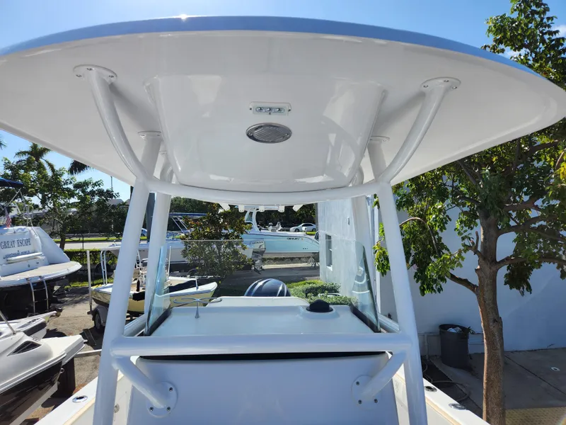 Slide: The Image of 2023 Century 2301 Center Console boat with T-top, docked outdoors. - 25