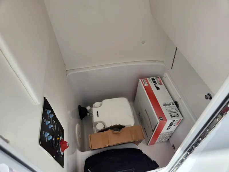 Slide: The Image of Interior storage compartment of 2023 Century 2301 Center Console boat with various items. - 26