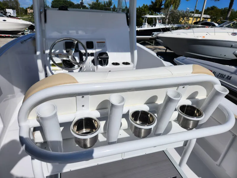 Slide: The Image of 2023 Century 2301 Center Console boat interior with rod holders and steering wheel. - 28