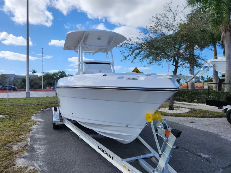 Slide: The Image of 2023 Century 2301 Center Console boat on trailer, parked outdoors under blue sky. - 35
