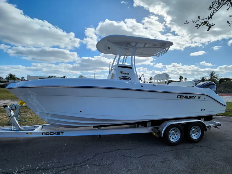 Slide: The Image of 2023 Century 2301 Center Console boat on trailer under blue sky. - 36