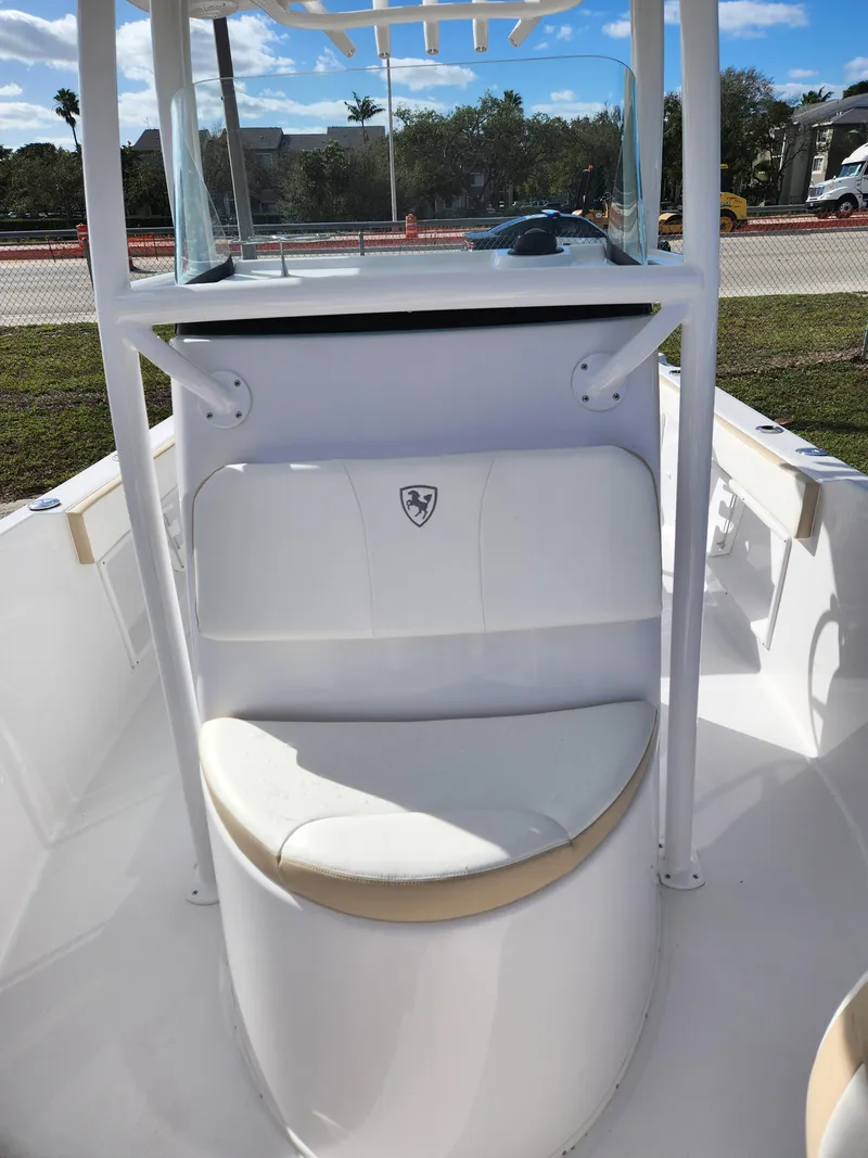 Slide: The Image of 2023 Century 2301 Center Console boat with seating and console, outdoors. - 38