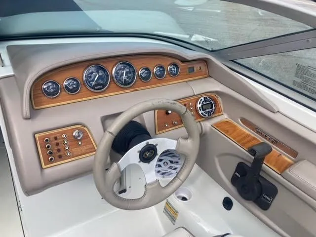 Slide: The Image of Dashboard of a 2000 Cobalt 246 boat with wood accents and gauges. - 14