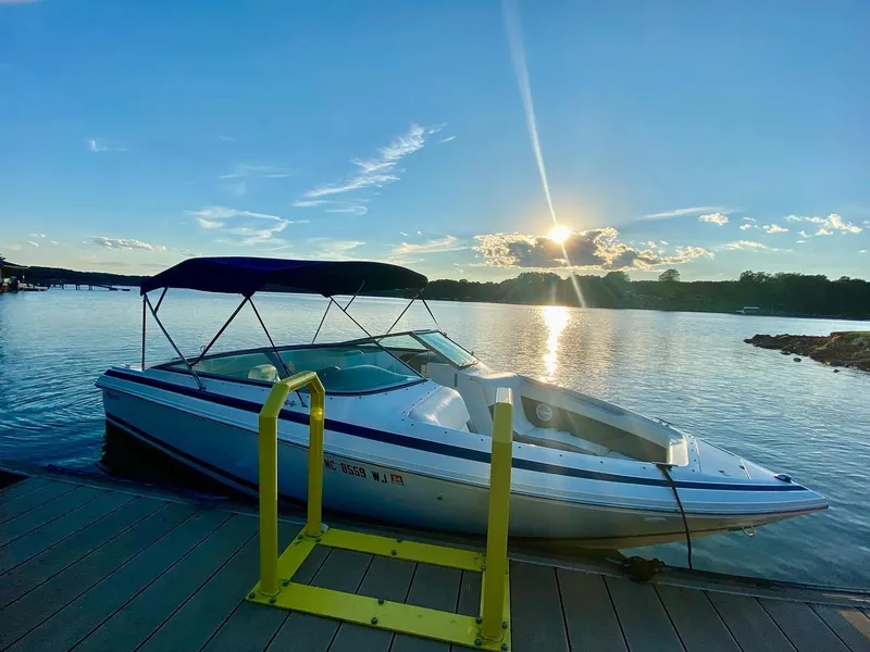 Slide: The Image of Cobalt 246 boat docked at sunset on a serene lake, 2000 model. - 3