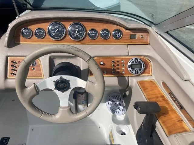 Slide: The Image of Cobalt 246 boat dashboard, 2000 model, featuring wood accents and multiple gauges. - 9