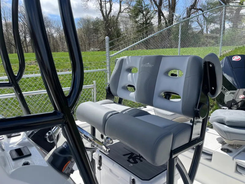 Slide: The Image of 2023 NauticStar 227 Bay boat with cushioned seating and console. - 6